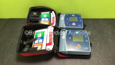 2 x Philips Heartstart FR2+ Defibrillators with 2 x Batteries *Install Dates 2021 / 2022* and 2 x Electrode Packs *Both Expired* in Carry Cases (Both Power Up)