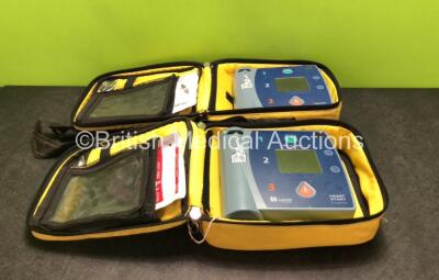 2 x Laerdal Heartstart FR2+ Defibrillators with 2 x Batteries *Install Dates 2021 / 2022* and 2 x Electrode Packs *Both Expired* in Carry Cases (Both Power Up)