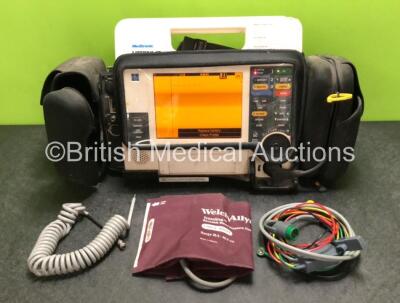 Medtronic Lifepak 12 Biphasic Defibrillator / Monitor Including Pacer, ECG, CO2, SpO2 and NIBP Options with BP Cuff, Hose and ECG Lead in Carry Case (Powers Up with Damage to Casing and Low Battery - See Photos)