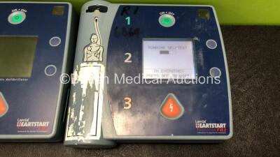 3 x Philips Heartstart FR2+ Defibrillators with 3 x Philips M3863A Batteries (1 x Powers Up and Passes Self Test, 2 x No Power) - 2