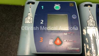 3 x Philips Heartstart FR2+ Defibrillators with 3 x Philips M3863A Batteries (1 x Powers Up and Passes Self Test, 2 x No Power) - 5