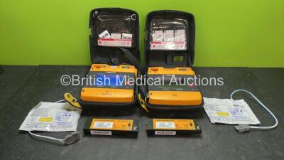 2 x Medtronic Physio-Control Lifepak 1000 Defibrillators with 4 x Batteries, 2 x Electrodes in 2 x Carry Cases (Both Power Up with Damage-See Photos)