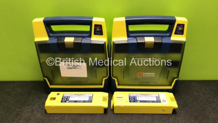 2 x Cardiac Science Powerheart AED G3 Automated External Defibrillators with 4 x Batteries (Both Power Up, 1 x Requires Service)