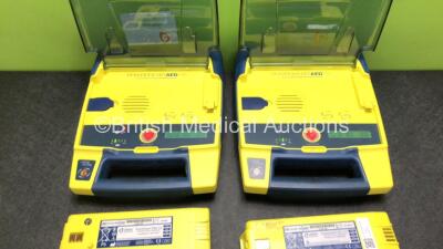 2 x Cardiac Science Powerheart AED G3 Automated External Defibrillators with 4 x Batteries (Both Power Up, 1 x Requires Service) - 2