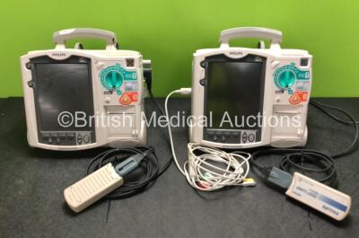 2 x Philips Heartstart MRx Defibrillators Including ECG and Printer Options with 2 x M3725A Test Loads, 2 x Paddle Leads, 1 x ECG Lead, 1 x Battery and 1 x M33539A Module (Both Power Up, 1 x Slight Damage to Casing - See Photos)