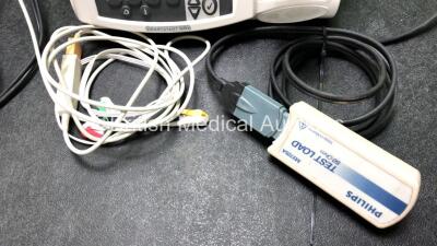 2 x Philips Heartstart MRx Defibrillators Including ECG and Printer Options with 2 x M3725A Test Loads, 2 x Paddle Leads, 1 x ECG Lead, 1 x Battery and 1 x M33539A Module (Both Power Up, 1 x Slight Damage to Casing - See Photos) - 4