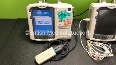 2 x Philips Heartstart MRx Defibrillators Including ECG and Printer Options with 2 x M3725A Test Loads, 2 x Paddle Leads, 1 x ECG Lead, 1 x Battery and 1 x M33539A Module (Both Power Up, 1 x Slight Damage to Casing - See Photos) - 5