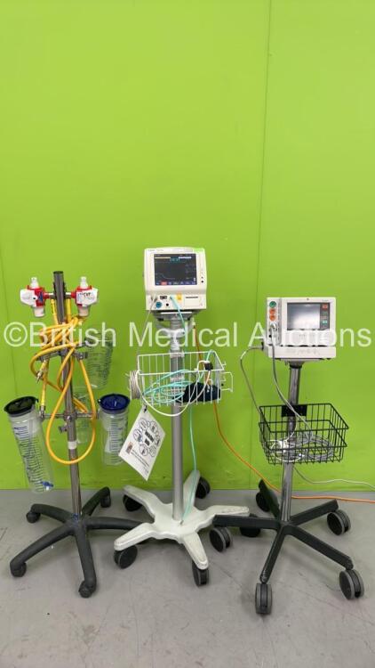 Mixed Lot Including Fukuda Denshi Dynascope DS-5100E Patient Monitor on Stand, 1 x Fukuda Denshi Dynascope DS-7100 Patient Monitor on Stand and 1 x Regulator on Stand (Both Power Up) *S/N 09070065 / 500000449*