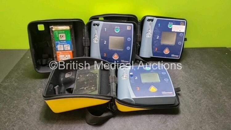 3 x Laerdal Heartstart FR2 Defibrillators (All Power Up with Stock Batteries, Batteries Not Included) In Carry Cases