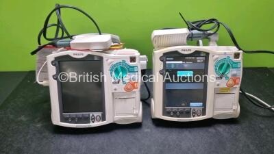 2 x Philips Heartstart MRx Defibrillators / Monitors Including ECG, and Printer Options (Both Power Up) with 2 x Paddle Leads, 1 x 3 Lead ECG Lead, 2 x Philips M3725A Test Loads, 1 x M3538A Battery and 1 x Philips M3539A Module