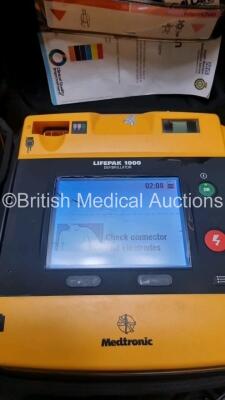 2 x Medtronic Physio Control Lifepak 1000 Defibrillators *Mfd 2008 / 2010* (Both Power Up) with 2 x 3 Lead ECG Lead and 3 x Physio Control 1000 Batteries *Li/Mn02* - 2