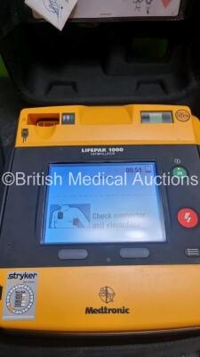 2 x Medtronic Physio Control Lifepak 1000 Defibrillators *Mfd 2008 / 2010* (Both Power Up) with 2 x 3 Lead ECG Lead and 3 x Physio Control 1000 Batteries *Li/Mn02* - 3