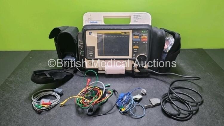 Medtronic Lifepak 12 Biphasic Defibrillator *Mfd 2004* P/N VLP12-02-005382 (Powers Up and Passes Self Test, Damage to Casing - See Photos) Including ECG, SpO2, NIBP Options with 1 x Ref 1111-000021 4 Lead ECG Lead, 1 x Ref 11111-000023 6 Lead ECG Lead, 2