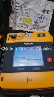 2 x Medtronic Physio Control Lifepak 1000 Defibrillators *Mfd 2021 / 2008* (Both Power Up) with 2 x 3 Lead ECG Lead , 3 x in Date Electrode Packs and 3 x Physio Control 1000 Batteries *Li/Mn02* - 2