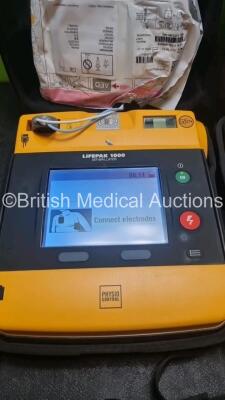 2 x Medtronic Physio Control Lifepak 1000 Defibrillators *Mfd 2016 / 2018* (Both Power Up) with 2 x 3 Lead ECG Lead , 3 x in Date Electrode Packs and 3 x Physio Control 1000 Batteries *Li/Mn02* - 3