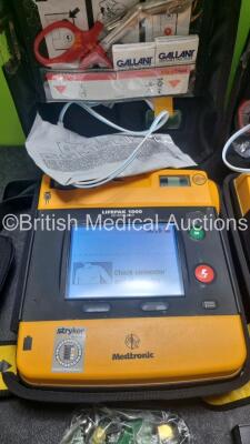 2 x Medtronic Physio Control Lifepak 1000 Defibrillators *Mfd 2008 / 2009* (Both Power Up 1 x Crack In Screen - See Photo) with 2 x 3 Lead ECG Lead , 2 x in Date Electrode Packs and 3 x Physio Control 1000 Batteries *Li/Mn02* - 4