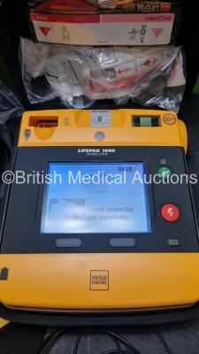 2 x Medtronic Physio Control Lifepak 1000 Defibrillators *Mfd 2016 / 2019* (Both Power Up) with 2 x 3 Lead ECG Lead , 5 x in Date Electrode Packs and 3 x Physio Control 1000 Batteries *Li/Mn02* - 2