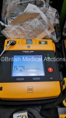 2 x Medtronic Physio Control Lifepak 1000 Defibrillators *Mfd 2016 / 2019* (Both Power Up) with 2 x 3 Lead ECG Lead , 5 x in Date Electrode Packs and 3 x Physio Control 1000 Batteries *Li/Mn02* - 3