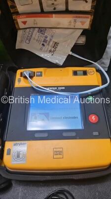 2 x Medtronic Physio Control Lifepak 1000 Defibrillators *Mfd 209 / 2011* (Both Power Up 1 x Crack In Screen - See Photo) with 2 x 3 Lead ECG Lead , 3 x in Date Electrode Packs and 3 x Physio Control 1000 Batteries *Li/Mn02* - 2