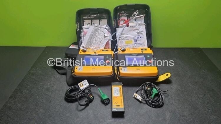 2 x Medtronic Physio Control Lifepak 1000 Defibrillators *Mfd 2017 / 2021* (Both Power Up 1 x with Marks on Screen - See Photo) with 2 x 3 Lead ECG Lead , 4 x in Date Electrode Packs and 3 x Physio Control 1000 Batteries *Li/Mn02*