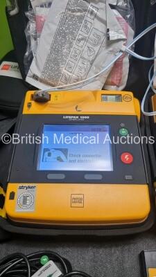 2 x Medtronic Physio Control Lifepak 1000 Defibrillators *Mfd 2017 / 2021* (Both Power Up 1 x with Marks on Screen - See Photo) with 2 x 3 Lead ECG Lead , 4 x in Date Electrode Packs and 3 x Physio Control 1000 Batteries *Li/Mn02* - 3