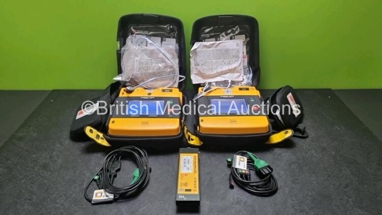 2 x Medtronic Physio Control Lifepak 1000 Defibrillators *Mfd 2019 / 2015* (Both Power Up) with 2 x 3 Lead ECG Lead and 4 x Physio Control 1000 Batteries *Li/Mn02*