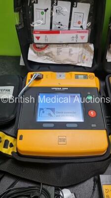 2 x Medtronic Physio Control Lifepak 1000 Defibrillators *Mfd 2016 / 2018* (Both Power Up) with 2 x 3 Lead ECG Lead , 3 x in Date Electrode Packs and 3 x Physio Control 1000 Batteries *Li/Mn02* - 3