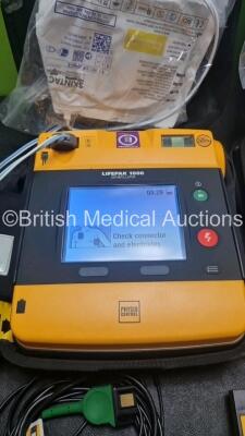 2 x Medtronic Physio Control Lifepak 1000 Defibrillators *Mfd 2016 / 2014* (Both Power Up) with 2 x 3 Lead ECG Lead , 4 x in Date Electrode Packs and 3 x Physio Control 1000 Batteries *Li/Mn02* - 3