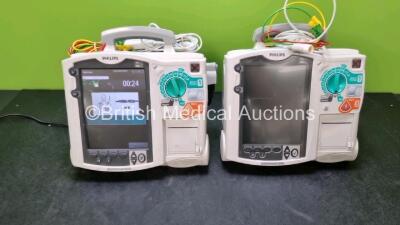 2 x Philips MRx Heartstart Defibrillators Including Pacer, ECG and Printer Options (Both Power Up) with 2 x 3 Lead ECG Leads, 1 x Paddle Leads and 1 x M3538A Module