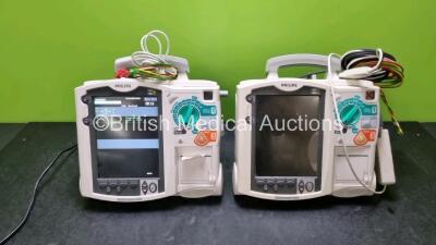 2 x Philips MRx Heartstart Defibrillators Including Pacer, ECG and Printer Options (Both Power Up) with 2 x 3 Lead ECG Leads, 1 x Paddle Leads, 1 x M3725A Test Load and 1 x M3538A Module