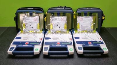 3 x Cardiac Science Powerheart AED G3 Automated External Defibrillators (All Power Up with Stock Battery Stock Battery Not Included) In Carry Case with 3 x In Date Electrode Packs