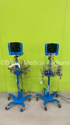 2 x GE Dinamap V100 Patient Monitors on Stands with 2 x AC Power Supplies 2 x NIBP Hoses and 2 x SpO2 Leads (Both Power Up) *SN SDT10110741SP, SH61202321SA*