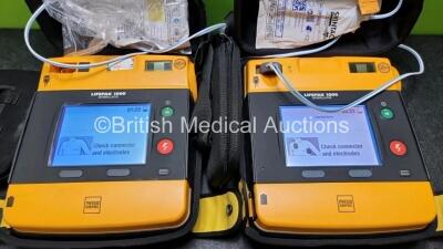 2 x Medtronic Physio Control Lifepak 1000 Defibrillators *Mfd 2012 / 2018* (Both Power Up , 1 x with Crack In Casing - See Photo) with 2 x 3 Lead ECG Leads and 2 x Batteries *Install Before 2023 / 2024* - 2