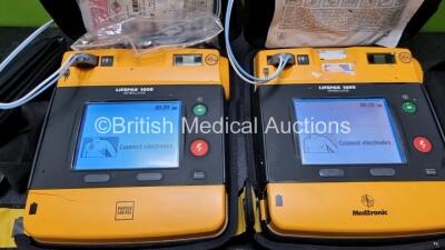 2 x Medtronic Physio Control Lifepak 1000 Defibrillators *Mfd 2011 / 2009* (Both Power Up) with 2 x 3 Lead ECG Leads and 2 x Batteries *Install Before 2023 / 2024* - 2