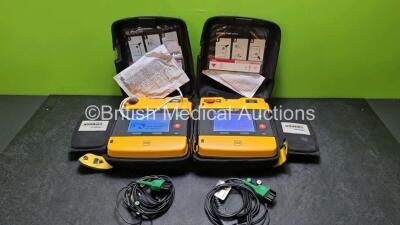 2 x Medtronic Physio Control Lifepak 1000 Defibrillators *Mfd 2014 / 2018* (Both Power Up Both with Crack In Casing - See Photos) with 2 x 3 Lead ECG Leads and 2 x Batteries *Install Before - 2024*