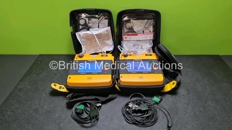 2 x Medtronic Physio Control Lifepak 1000 Defibrillators *Mfd 2012 / 2018* (Both Power Up, 1 x with Crack in Casing - See Photo) with 2 x 3 Lead ECG Leads and 2 x Batteries *Install Before - 2024*