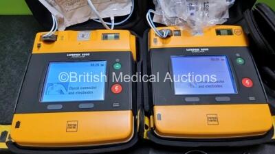 2 x Medtronic Physio Control Lifepak 1000 Defibrillators *Mfd 2012 / 2018* (Both Power Up, 1 x with Crack in Casing - See Photo) with 2 x 3 Lead ECG Leads and 2 x Batteries *Install Before - 2024* - 2