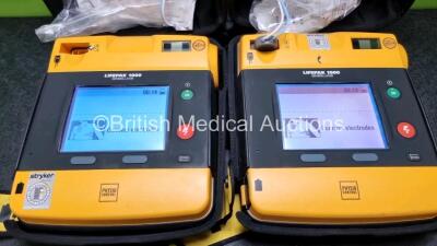 2 x Medtronic Physio Control Lifepak 1000 Defibrillators *Mfd - 2018* (Both Power Up, 1 x with Slight Crack In Casing - See Photo) with 2 x 3 Lead ECG Leads and 2 x Batteries *Install Before 2023 / 2024* - 2