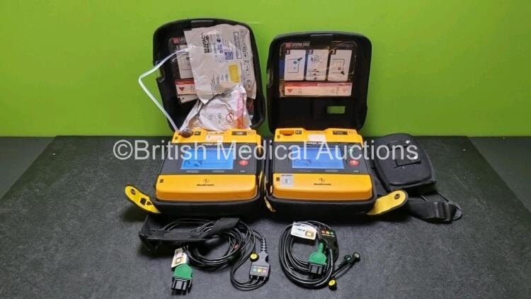 2 x Medtronic Physio Control Lifepak 1000 Defibrillators *Mfd - 2008* (Both Power Up,1 x with Crack In Casing and In Screen - See Photos) with 2 x 3 Lead ECG Leads and 2 x Batteries *Install Before 2023 / 2024*