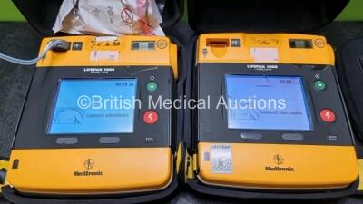 2 x Medtronic Physio Control Lifepak 1000 Defibrillators *Mfd - 2008* (Both Power Up,1 x with Crack In Casing and In Screen - See Photos) with 2 x 3 Lead ECG Leads and 2 x Batteries *Install Before 2023 / 2024* - 2