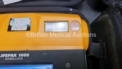 2 x Medtronic Physio Control Lifepak 1000 Defibrillators *Mfd 2012 / 2011* (Both Power Up) with 2 x 3 Lead ECG Leads and 2 x Batteries *Install Before 2022 / 2024* - 3