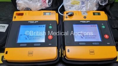 2 x Medtronic Physio Control Lifepak 1000 Defibrillators *Mfd 2019 / 2018* (Both Power Up) with 2 x 3 Lead ECG Leads and 2 x Batteries *Install Before 2024* - 2