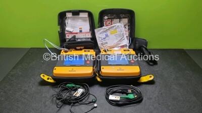 2 x Medtronic Physio Control Lifepak 1000 Defibrillators *Mfd 2010 / 2008* (Both Power Up Both with Crack In Casing and In Screen - See Photo) with 2 x 3 Lead ECG Leads and 2 x Batteries *Install Before 2024*