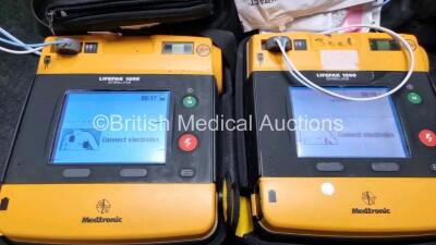 2 x Medtronic Physio Control Lifepak 1000 Defibrillators *Mfd 2010 / 2008* (Both Power Up Both with Crack In Casing and In Screen - See Photo) with 2 x 3 Lead ECG Leads and 2 x Batteries *Install Before 2024* - 2