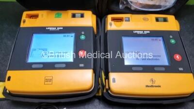 2 x Medtronic Physio Control Lifepak 1000 Defibrillators *Mfd 2021 / 2008* (Both Power Up) with 2 x 3 Lead ECG Leads and 2 x Batteries *Install Before 2026 / 2024* - 2