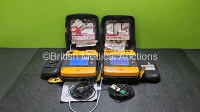 2 x Medtronic Physio Control Lifepak 1000 Defibrillators *Mfd 2012 / 2018* (Both Power Up Both with Slight Crack In Casing - See Photos) with 2 x 3 Lead ECG Leads and 2 x Batteries *Install Before 2027 / 2024*