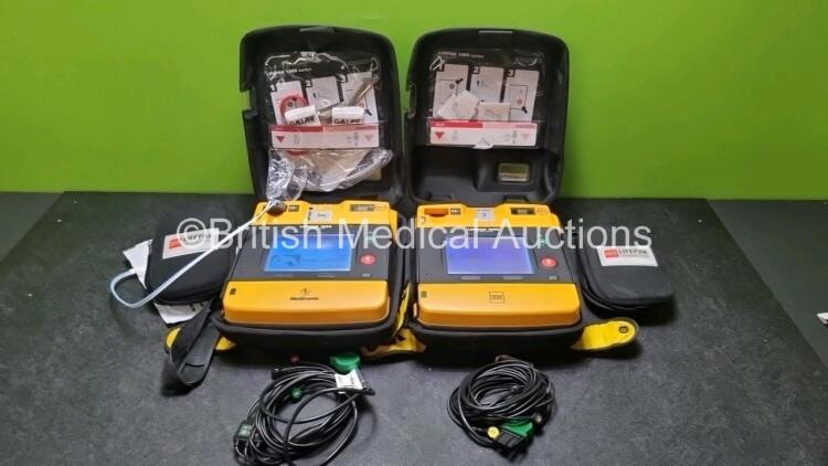 2 x Medtronic Physio Control Lifepak 1000 Defibrillators *Mfd 2012 / 2018* (Both Power Up Both with Slight Crack In Casing - See Photos) with 2 x 3 Lead ECG Leads and 2 x Batteries *Install Before 2024*