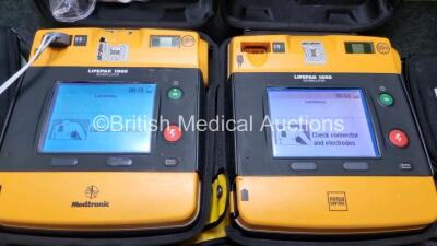 2 x Medtronic Physio Control Lifepak 1000 Defibrillators *Mfd 2012 / 2018* (Both Power Up Both with Slight Crack In Casing - See Photos) with 2 x 3 Lead ECG Leads and 2 x Batteries *Install Before 2024* - 2