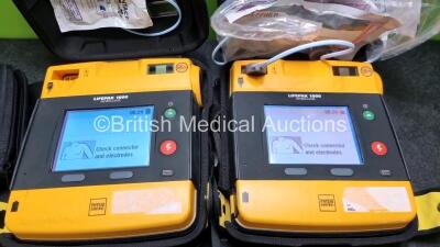 2 x Medtronic Physio Control Lifepak 1000 Defibrillators *Mfd 2015* (Both Power Up) with 2 x Batteries *Install Before 2021 / 2023* and 1 x 3 Lead ECG Lead *SN 43286655 / 44179430* - 2