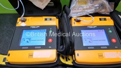 2 x Medtronic Physio Control Lifepak 1000 Defibrillators *Mfd 2015* (Both Power Up) with 2 x Batteries *Install Before 2021 / 2023* and 2 x 3 Lead ECG Lead *SN - 2